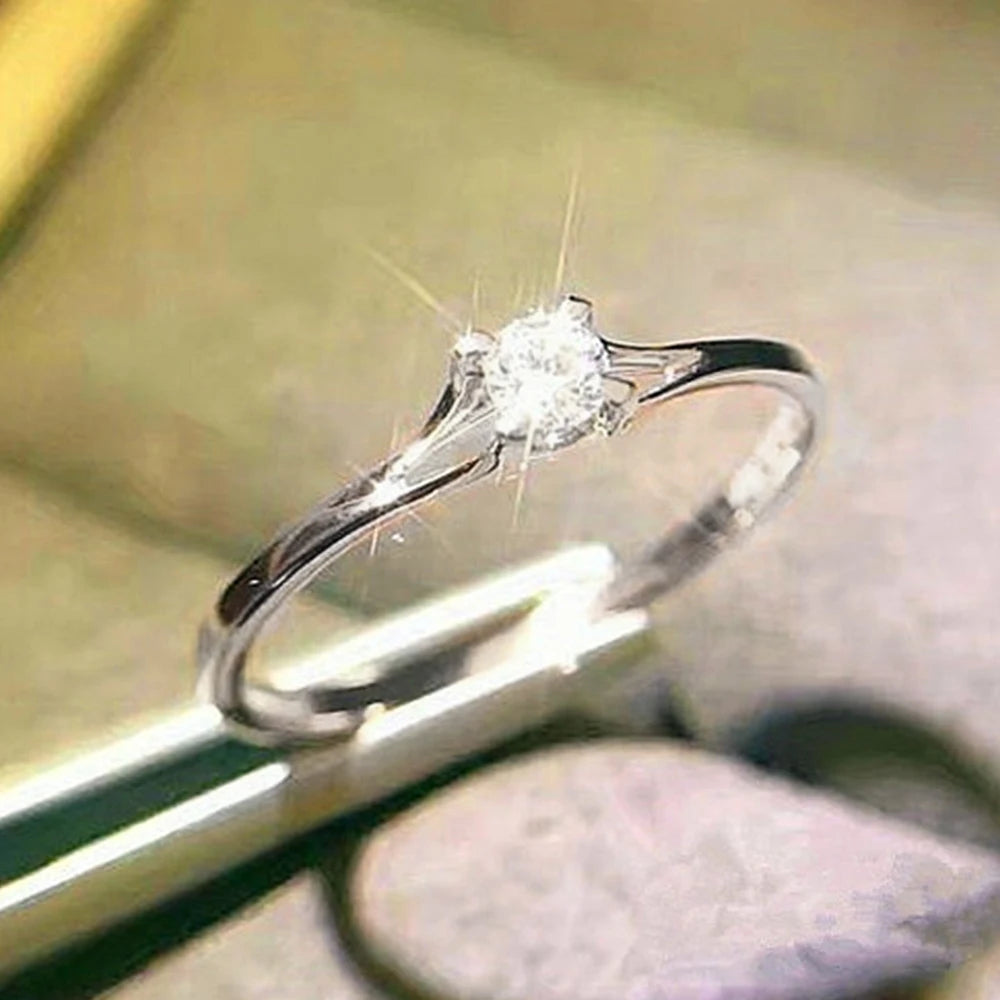 “Minimalist wedding ring with 4MM cubic zirconia, simple and elegant design.”