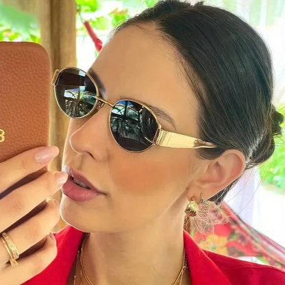 “Oval sunglasses with metal frame, trendy unisex design, classic shades.”