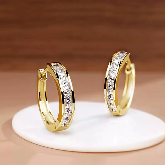 “Classic hoop earrings with princess-cut CZ, elegant and versatile women’s accessories.”