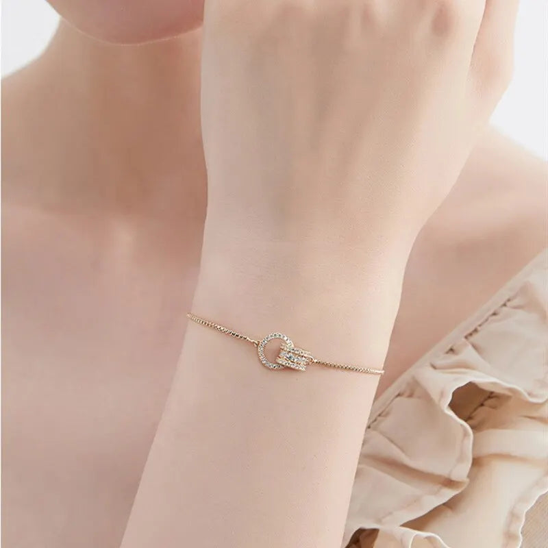 “Trendy Gold-Color Interlocked Circle Bangle, Unisex, Stylish Party Bracelet Accessory.”