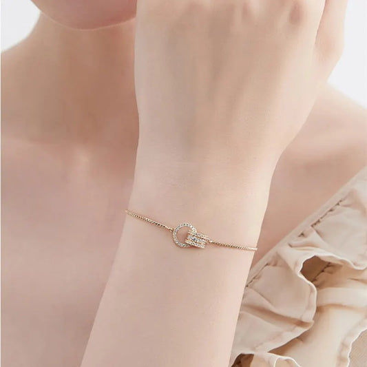 “Trendy Gold-Color Interlocked Circle Bangle, Unisex, Stylish Party Bracelet Accessory.”