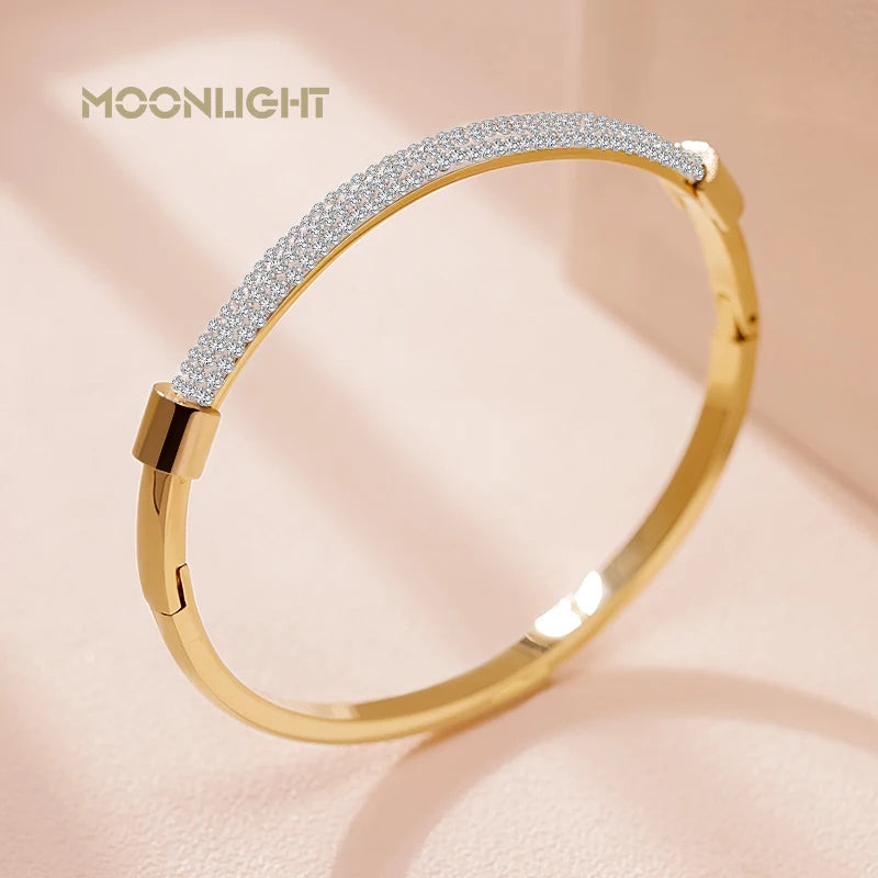 “Trendy titanium steel cuff bracelet with cubic zirconia, classic circular design.”