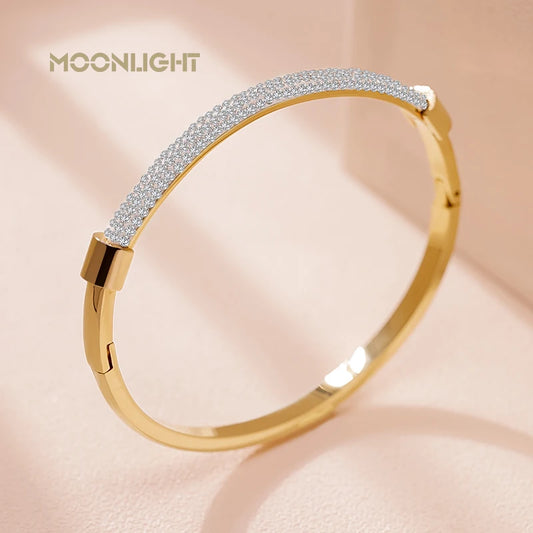 “Trendy titanium steel cuff bracelet with cubic zirconia, classic circular design.”