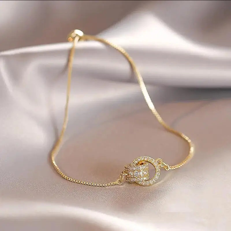 “Trendy Interlocked Gold-Color Circle Bangle for Women, Exquisite Party Jewelry.”