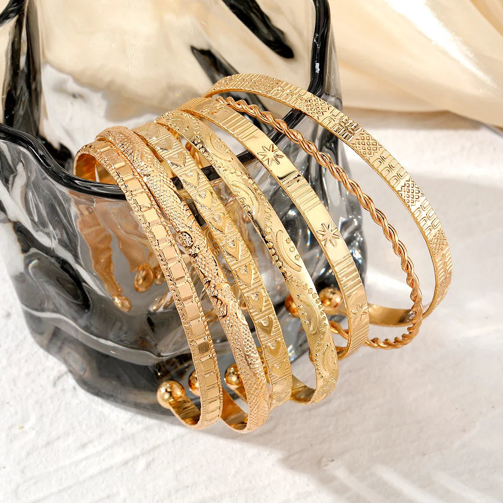 “7-piece gold bracelets set: punk heart designs, open bangles, trendy streetwear.”