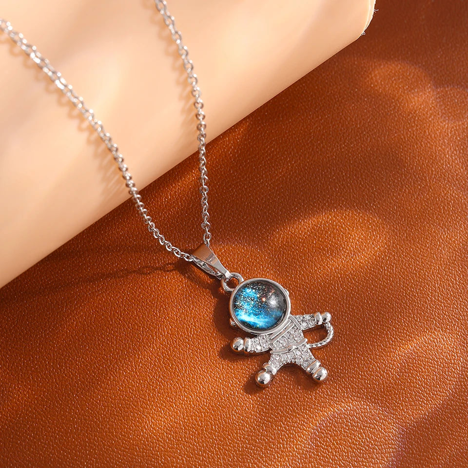 “Luxury gold titanium steel necklace with planet, moon, astronaut pendants.”