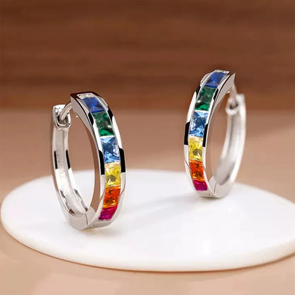 “Classic hoop earrings with princess-cut CZ, elegant and versatile women’s accessories.”