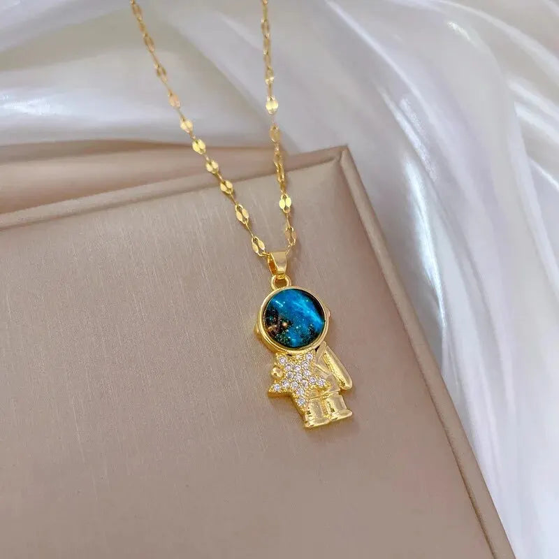 “Luxury gold titanium steel necklace with planet, moon, astronaut pendants.”