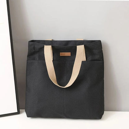 “Women’s solid color canvas tote bag, large capacity, casual, reusable, beach shopping.”