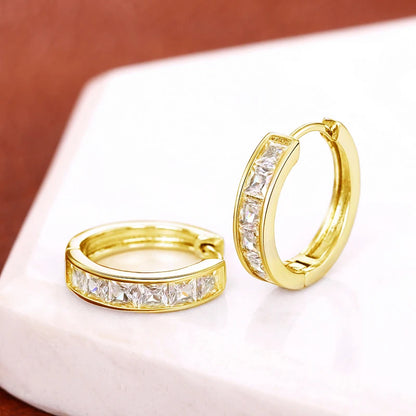 “Classic hoop earrings with princess-cut CZ, elegant and versatile women’s accessories.”