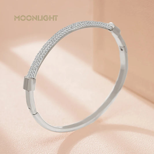 “Trendy titanium steel cuff bracelet with cubic zirconia, classic circular design.”