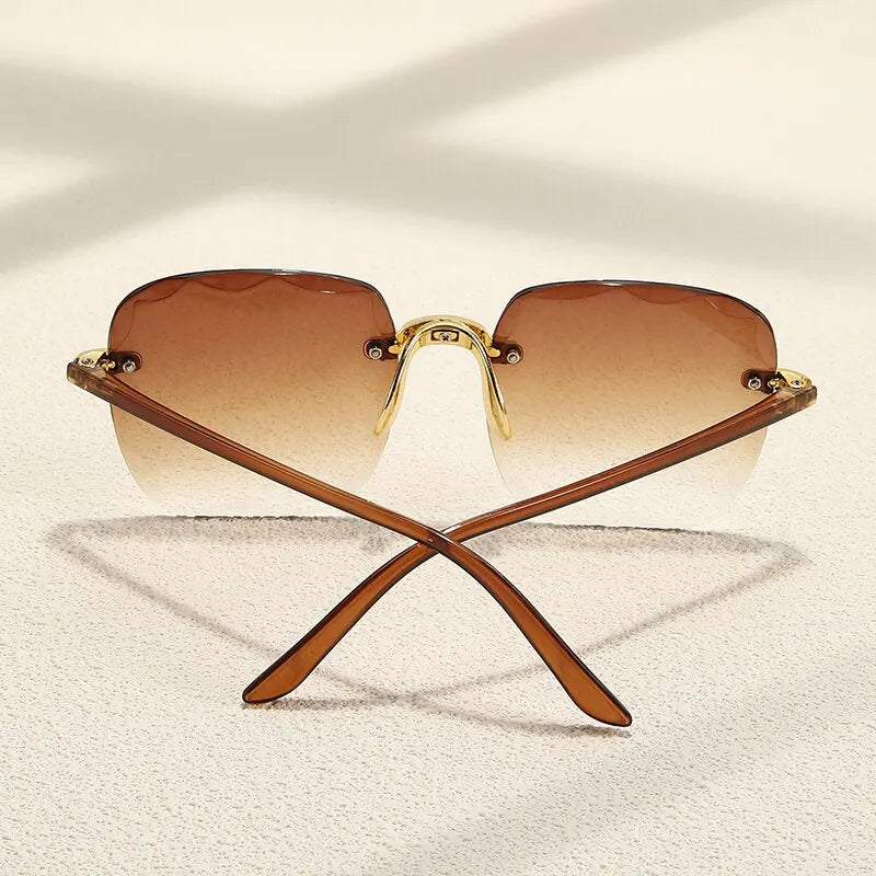 “Square frameless women’s sunglasses with classic gradient lenses.”