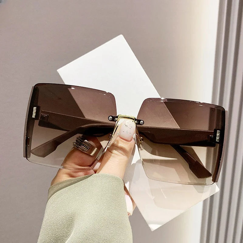 “Fashion rimless women’s sunglasses, gradient lenses, retro UV400 beach style.”