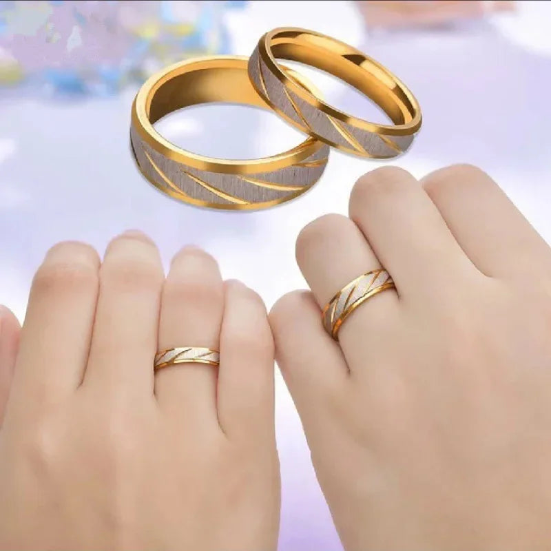 “Gold wave-pattern couple rings, stainless steel, perfect for weddings or promises.”