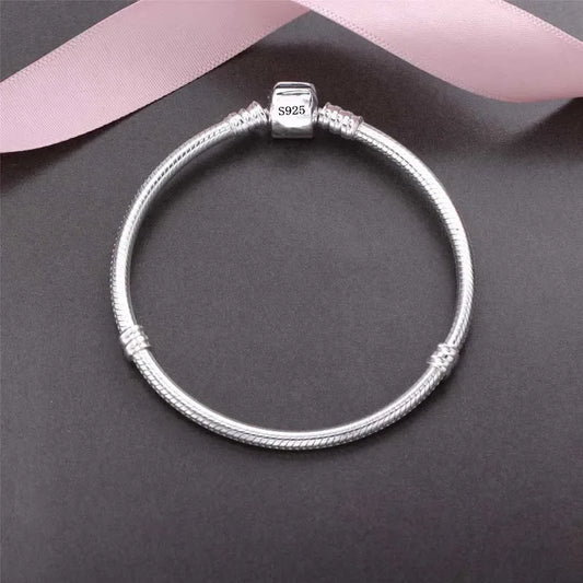 “Luxury Handmade 925 Sterling Silver Charm Bracelet - Smooth Snake Bone Design.”