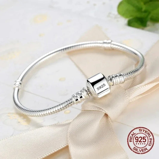 “Luxury Handmade 925 Sterling Silver Charm Bracelet - Smooth Snake Bone Design.”