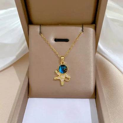 “Luxury gold titanium steel necklace with planet, moon, astronaut pendants.”