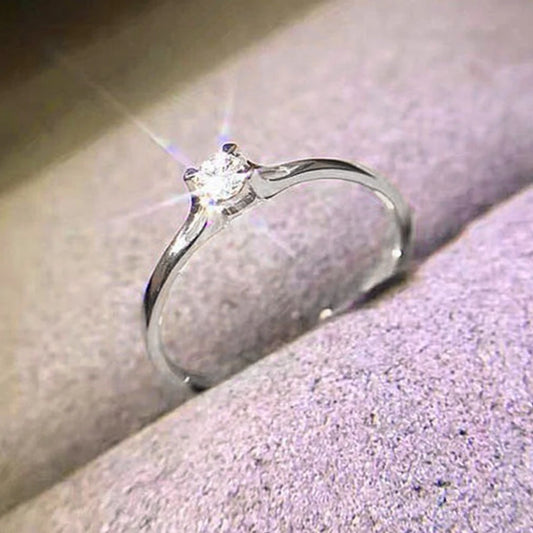 “Minimalist wedding ring with 4MM cubic zirconia, simple and elegant design.”