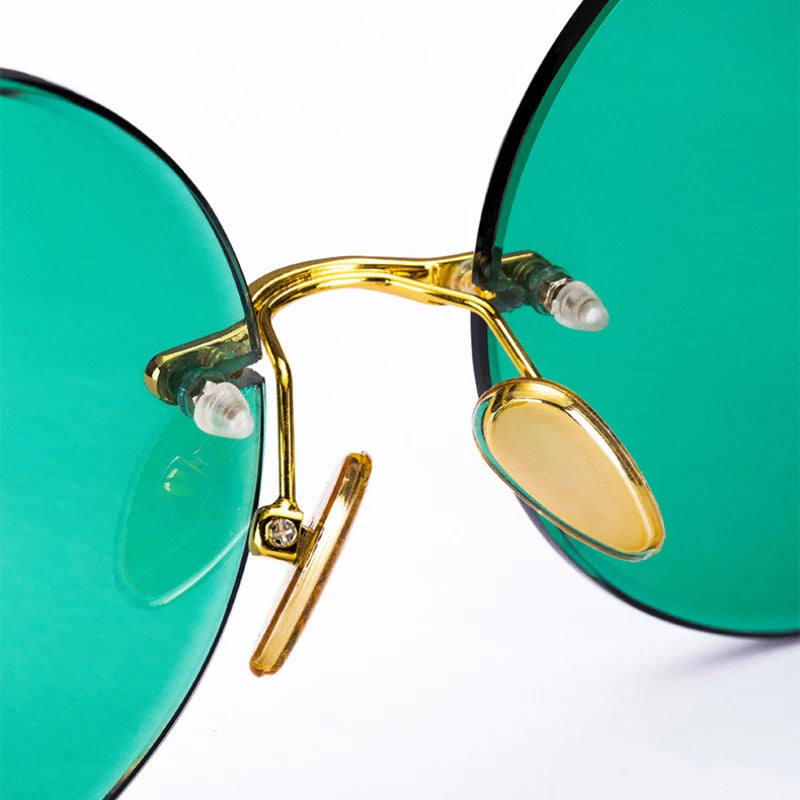 “Classic rimless sunglasses, retro round design, crystal green lenses for outdoor wear.”