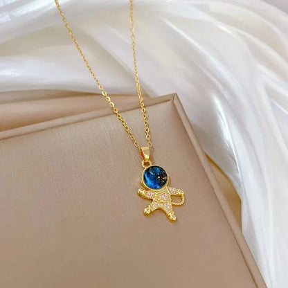 “Luxury gold titanium steel necklace with planet, moon, astronaut pendants.”