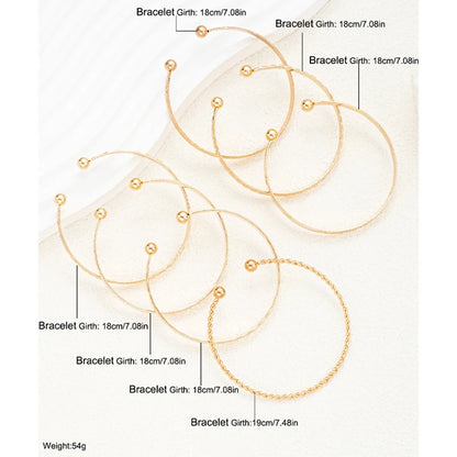 “7-piece gold bracelets set: punk heart designs, open bangles, trendy streetwear.”