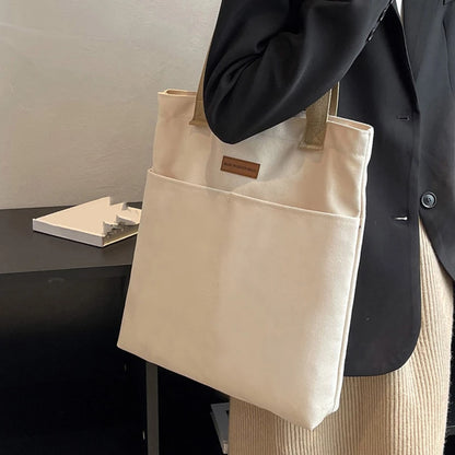 “Women’s solid color canvas tote bag, large capacity, casual, reusable, beach shopping.”