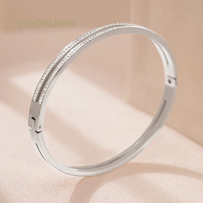 “Trendy titanium steel cuff bracelet with cubic zirconia, classic circular design.”