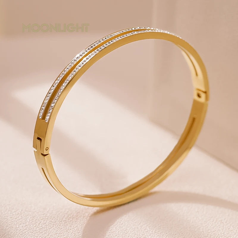 “Trendy titanium steel cuff bracelet with cubic zirconia, classic circular design.”