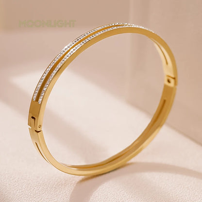 “Trendy titanium steel cuff bracelet with cubic zirconia, classic circular design.”