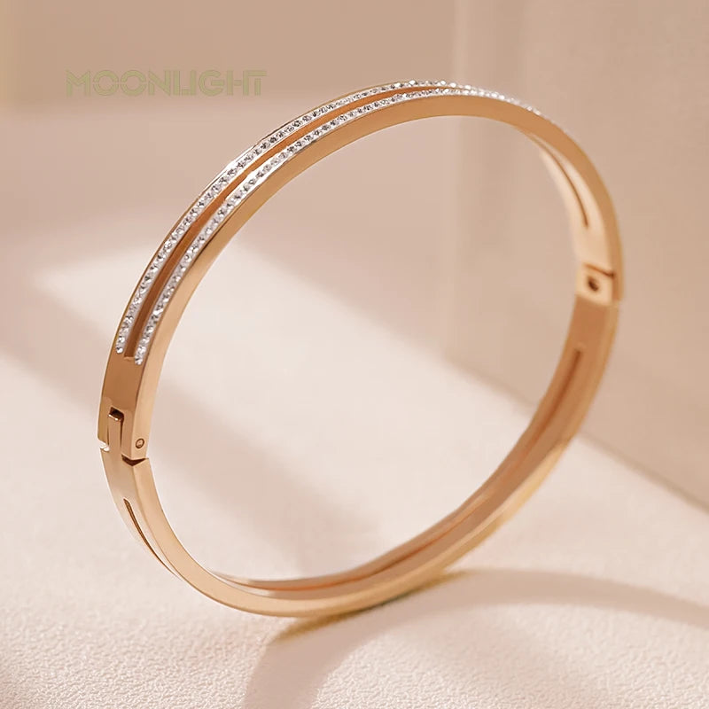 “Trendy titanium steel cuff bracelet with cubic zirconia, classic circular design.”