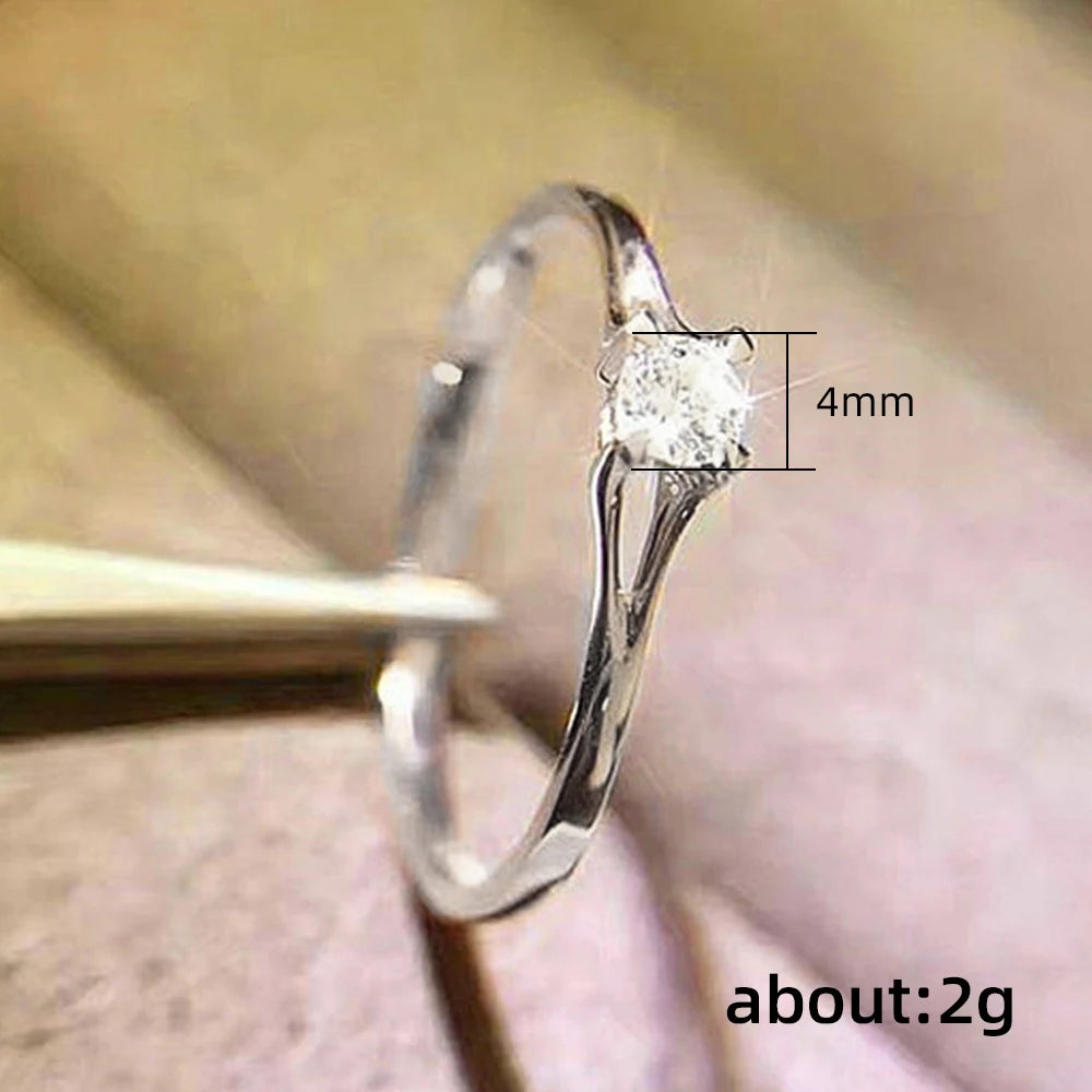 “Minimalist wedding ring with 4MM cubic zirconia, simple and elegant design.”