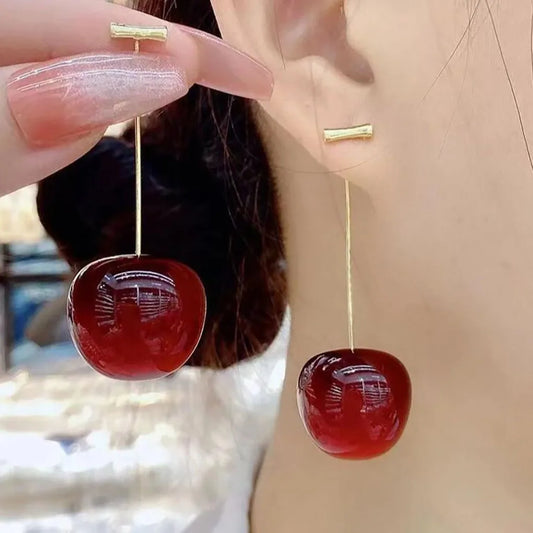 “Red cherry dangle earrings, fruit design, statement jewelry, perfect for parties.”