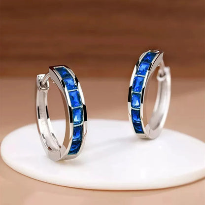 “Classic hoop earrings with princess-cut CZ, elegant and versatile women’s accessories.”