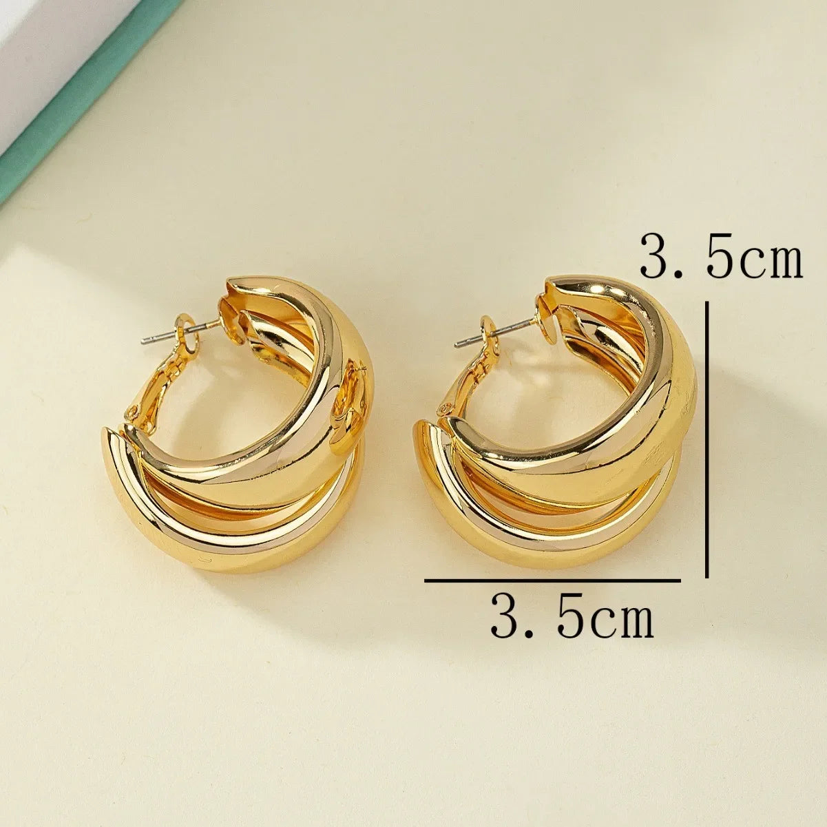 “Stainless Steel Chunky Hoop Earrings - Gold Double Ring Geometric Design.”