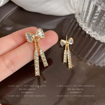“Gold Bow Stud Earrings for Women - Dainty Rhinestone Jewelry.”