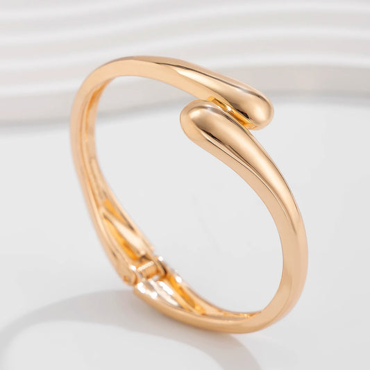 “Ingemark Creative Water Drop Metal Bangle - Gold Geometric Twisted Bracelet for Women.”